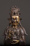 A Chinese parcel-gilt bronze figure of Xiwangmu