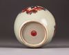 A Chinese celadon-ground 'nine peaches' ovoid jar