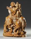 A CHINESE SOAPSTONE CARVED LUOHAN RIDING AN ELEPHANT, 19TH CENTURY