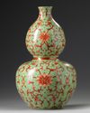 A Chinese lime green ground iron red decorated double gourd vase
