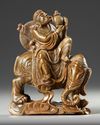 A CHINESE SOAPSTONE CARVED LUOHAN RIDING AN ELEPHANT, 19TH CENTURY