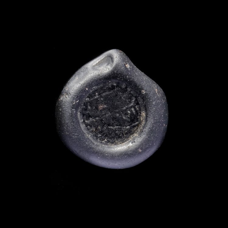 A FATIMID GLASS WEIGHT OF DOUBLE DIRHAM, EGYPT 10TH-11TH CENTURY