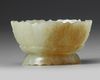 A CHINESE PALE AND RUSSET CARVED JADE 'LOTUS' CENSER