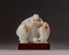 A Chinese pale celadon and russet jade boy and elephant group