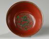 A Chinese red-ground green-enamelled 'dragon' bowl