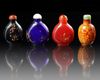 A GROUP OF FOUR CHINESE PEKING GLASS SNUFF BOTTLES