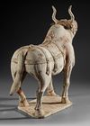 A VERY RARE LARGE OF A WALKING OX IN FULL HARNESS, CHINA, SIX DYNASTIES (220-582 AD)