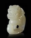 A CHINESE JADE CARVED BUDDHIST LION, 20TH CENTURY