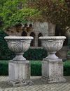 A PAIR OF CARVED LIMESTONE URNS ON PEDESTALS, LATE 20TH CENTURY