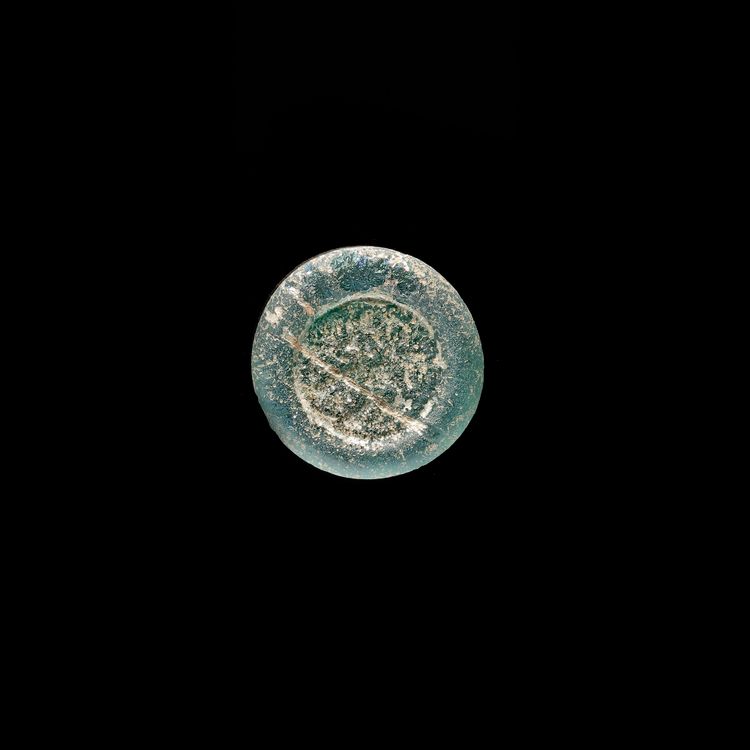 A FATIMID GLASS WEIGHT OF DIRHAM, AL-HAKIM BI-AMR ALLAH (386AH-411AH/ 996AD-1021AD)