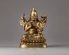 A Sino-Tibetan gilt bronze figure of a Lama