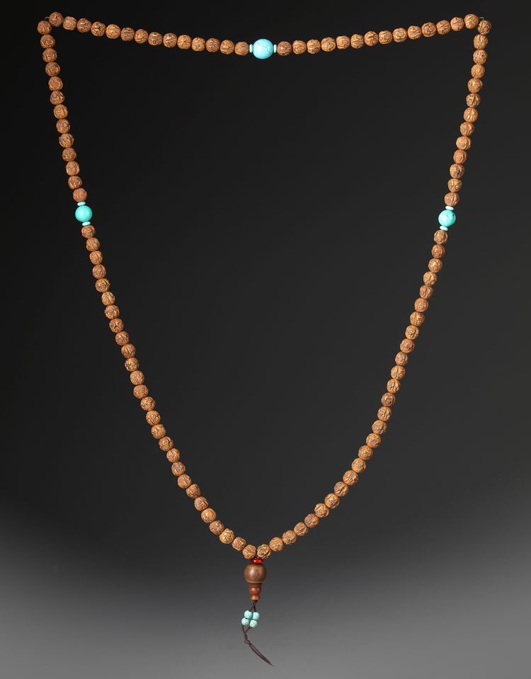 A CHINESE SEED CARVED PRAYER BEADS, 20TH CENTURY