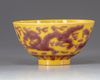 A CHINESE YELLOW-GROUND AUBERGINE-DECORATED 'DRAGON AND PHOENIX' BOWL