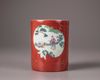 A Chinese coral-red ground famille rose brush pot