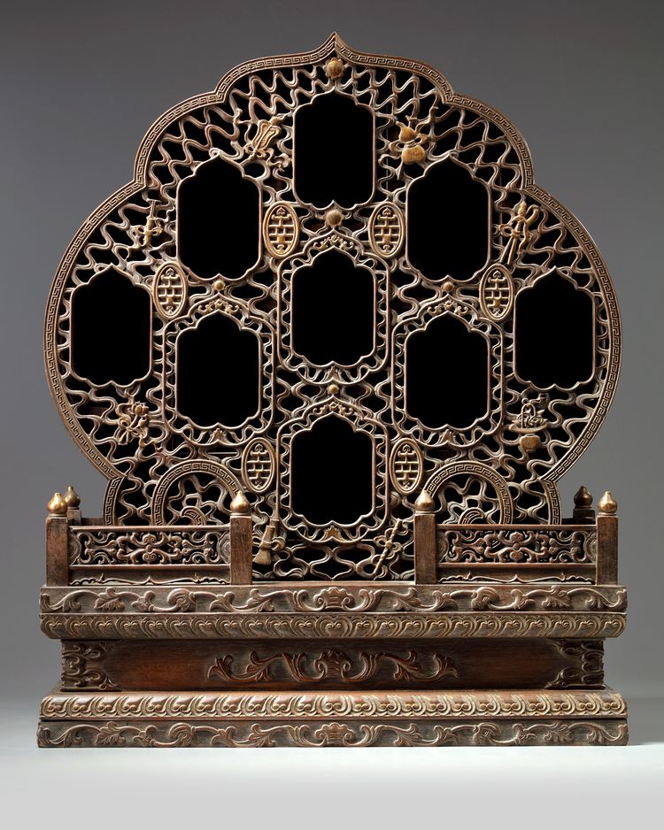 A Chinese hardwood parcel-gilt foliate altar cabinet