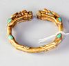 A SINO TIBETAN GILDED BANGLE, 19TH CENTURY