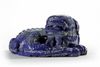 A Chinese lapis lazuli carving of a Buddhist lion on a gilt bronze champlevé enamel stand