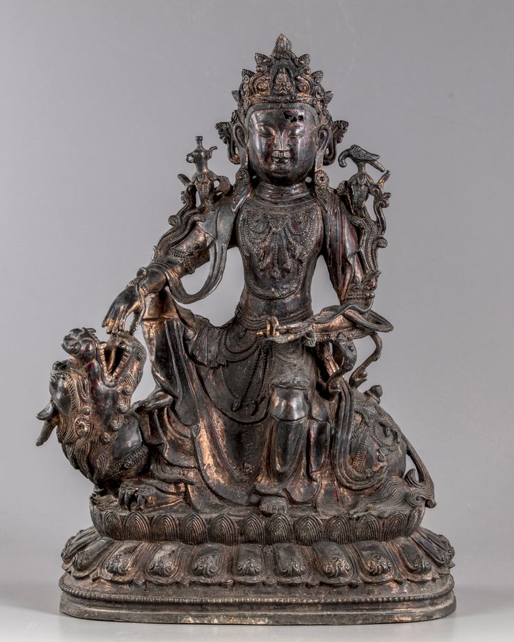 A partial gilt and lacquered figure of guanyin on a mythical beast