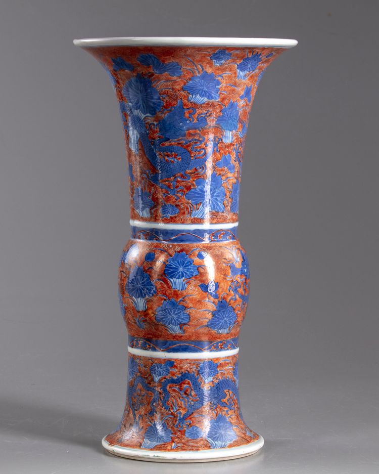 A Chinese iron-red-ground blue and white 'dragon and lotus' vase, gu