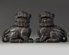 A pair of Chinese carved zitan wood Buddhist lions