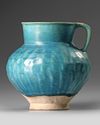 A TURQUOISE BLUE GLAZED POTTERY JUG, PERSIA-KASHAN, 12TH CENTURY