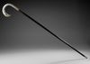 A SILVER-MOUNTED BLACK WOOD WALKING CANE WITH BIRD-HEAD HANDLE