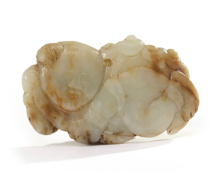 A Chinese pale celadon and russet jade 'boy and lingzhi' carving