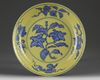 A Chinese yellow-ground blue and white 'gardenia' dish