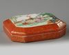 A Chinese coral-ground famille rose octagonal seal paste box and cover