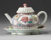 A CHINESE PINK-GROUND FAMILLE ROSE MOULDED 'CHRYSANTHEMUM' TEAPOT, COVER AND STAND