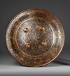 A QAJAR GOLD-DAMASCENED STEEL SHIELD,  PERSIA, 19TH CENTURY