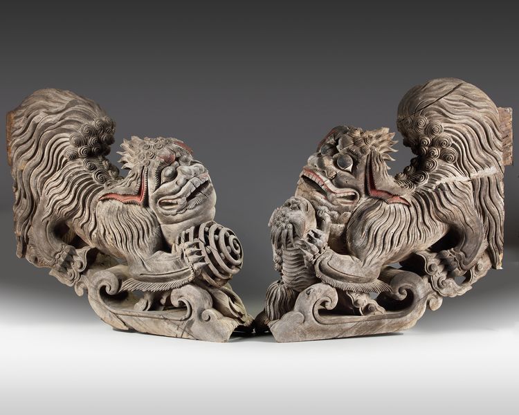 A rare set of two plain wooden corbels from Kyūshū with carved Chinese lions (karashishi)