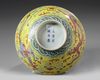 A Chinese yellow ground famille rose 'dragon and phoenix' bowl