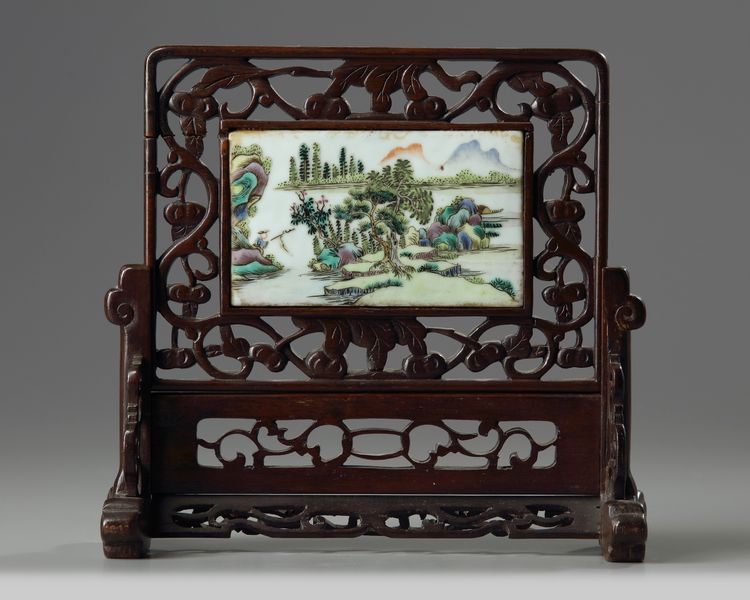 A Chinese famille verte plaque inset into a wooden table screen
