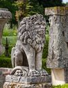 A SCULPTED LIMESTONE MODEL OF A SEATED LION, FIRST QUARTER 20TH CENTURY