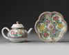 A CHINESE PINK-GROUND FAMILLE ROSE MOULDED 'CHRYSANTHEMUM' TEAPOT, COVER AND STAND