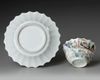 a CHINESE FAMILLE ROSE CHRYSANTHEMUM-FORM CUP AND SAUCER, EARLY QIANLONG PERIOD (1735-1795)
