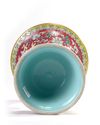 A Chinese ruby-ground famille rose 'bajixiang' gu vase