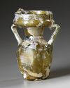 AN INTACT ROMAN OLIVE YELLOW GLASS TWIN-HANDLED JAR, CIRCA 4TH CENTURY A.D.