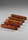 A GROUP OF FIVE QAJAR LACQUERED PAPIER-MACHÉ PEN CASES (QALAMDAN), 19TH CENTURY