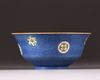 A Chinese blue-ground sgraffiato famille rose 'roundels' bowl
