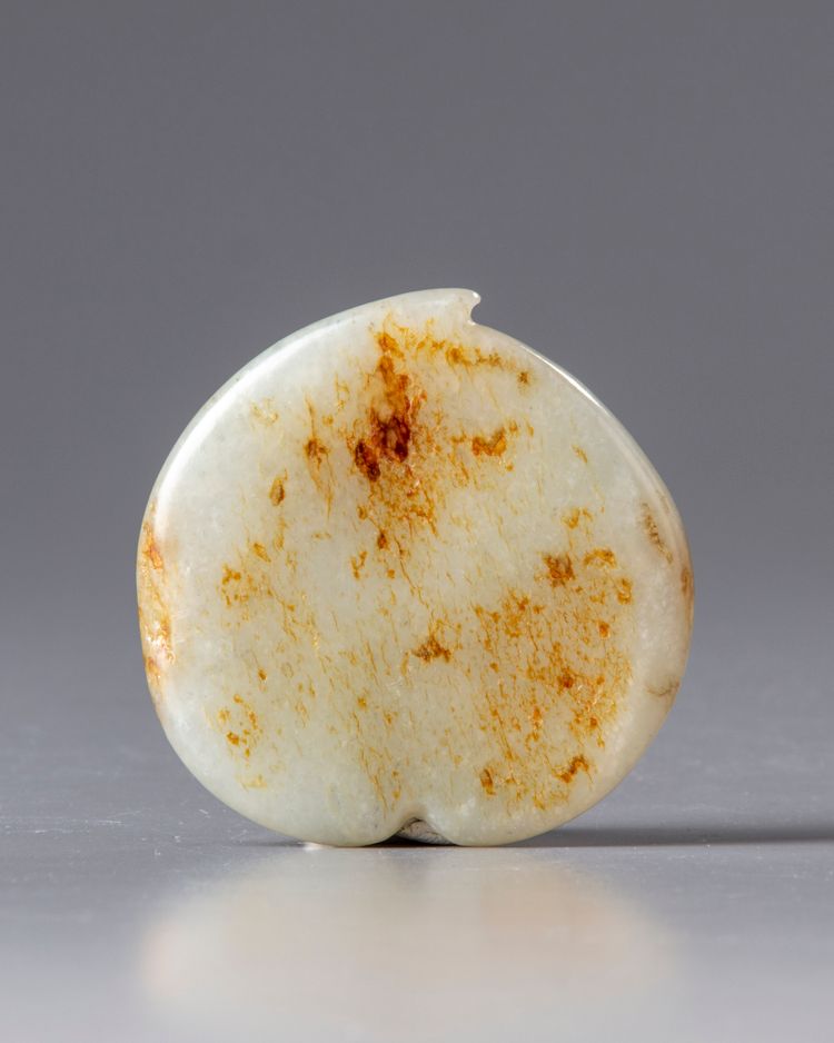 A white and russet jade 'peach' belt buckle