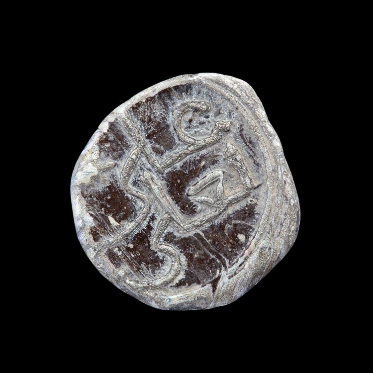 AN EARLY ISLAMIC GLASS VESSEL STAMP, 10TH-11TH CENTURY