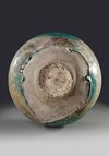 A KASHAN TURQUOISE GLAZED MOULDED BOTTLE VASE, PERSIA, 12TH CENTURY
