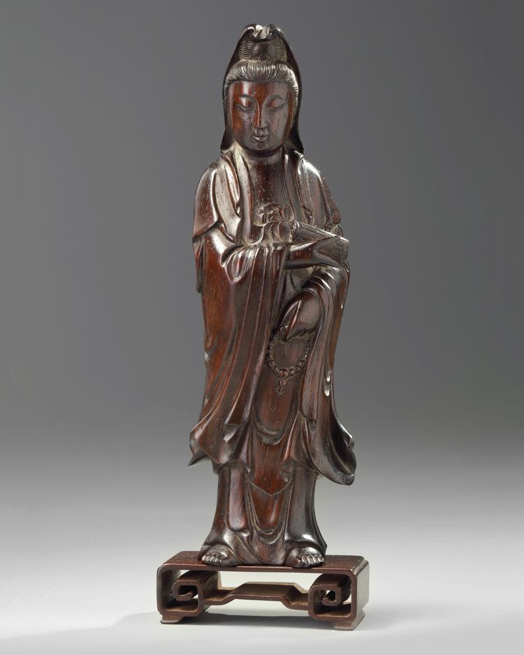 A Chinese hongmu carving of Guanyin and stand