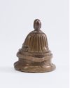 A Tibetan silver-inlaid bronze figure of a Lama