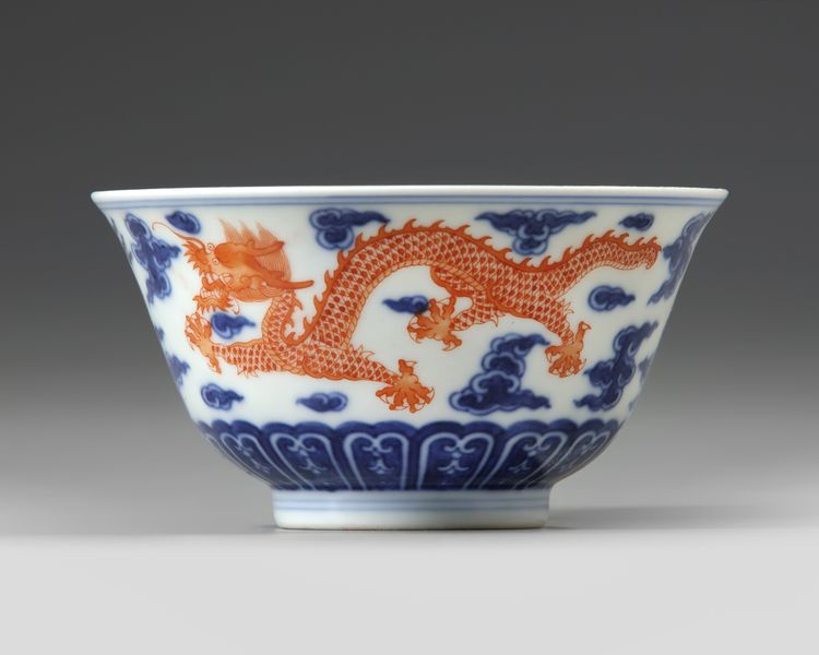 A CHINESE BLUE AND WHITE IRON-RED DECORATED 'DRAGON' BOWL, SIX-CHARACTER JIAQING MARK AND OF THE PERIOD (1796-1820)