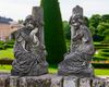 A PAIR OF CARVED WHITE MARBLE KNEELING CHILDREN AGAINST A TREE TRUNK BY F. BUSELL, FRENCH, LATE 19TH CENTURY
