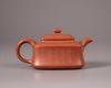 A Chinese yixing slip-decorated teapot and cover