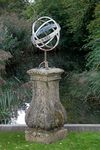 AN IRON ARMILLARY SUNDIAL ON A COMPOSTION STONE BASE IN LOUIS XIV STYLE,  LATE 19TH CENTURY